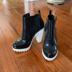 Melissa black boots with white bottoms and heels.